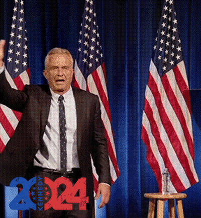 Man In Suit And Tie In Front Of American Flags 2014 GIF