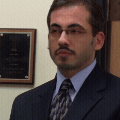 Man In Suit And Tie In Front Of Box Plaque GIF