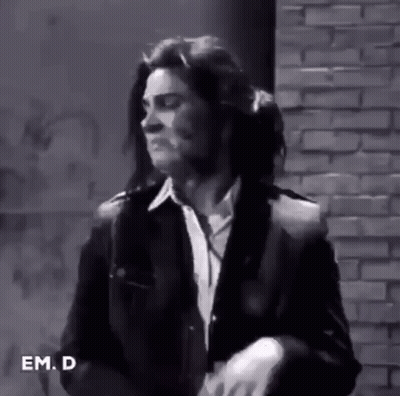 Man In Suit And Tie In Front Of Brick Wall GIF