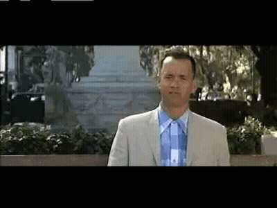 Man In Suit And Tie In Front Of Building GIF
