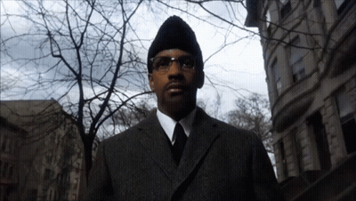 Man In Suit And Tie In Front Of Building GIF