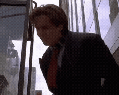 Man In Suit And Tie In Front Of Building GIF