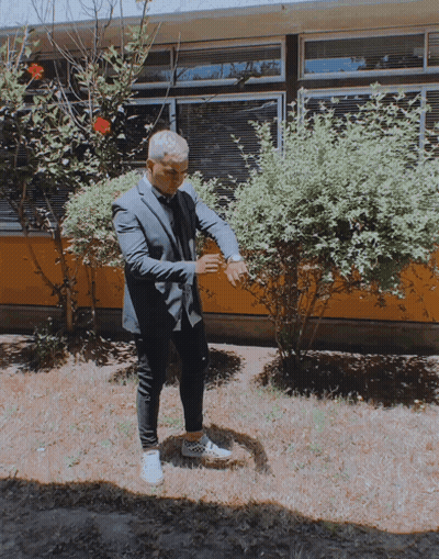 Man In Suit And Tie In Front Of Building GIF