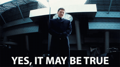 Man In Suit And Tie In Front Of Building GIF