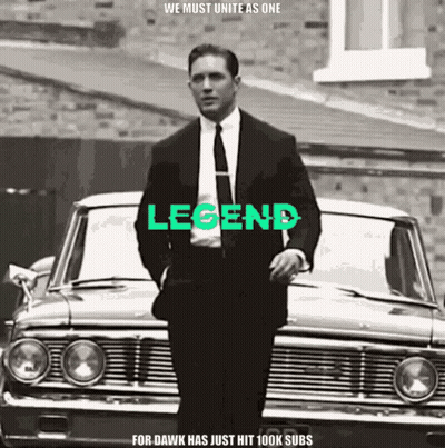 Man In Suit And Tie In Front Of Car With Legend GIF