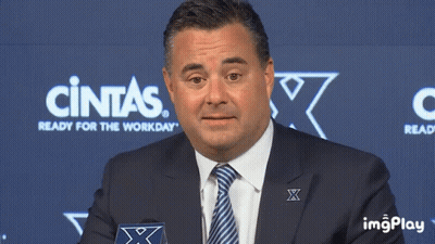 Man In Suit And Tie In Front Of Cintas Sign GIF