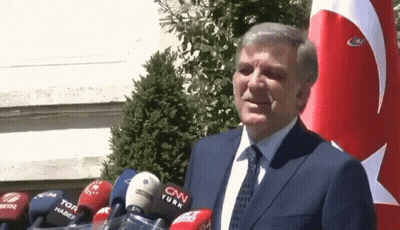 Man in Suit and Tie in Front of CNN Turk Microphones