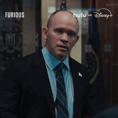 Man In Suit And Tie In Front Of Disney Logo GIF