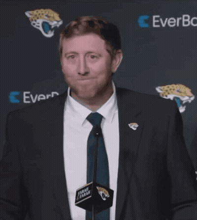 Man In Suit And Tie In Front Of EverBank Sign GIF