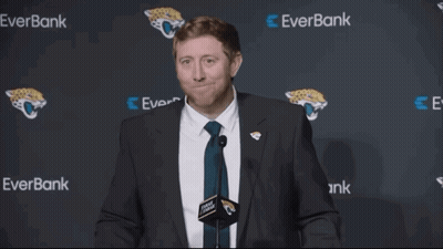 Man in Suit and Tie in Front of Everbank Wall