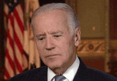 Man In Suit And Tie In Front Of Flag GIF