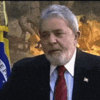 Man In Suit And Tie In Front Of Flag Saying Eee GIF