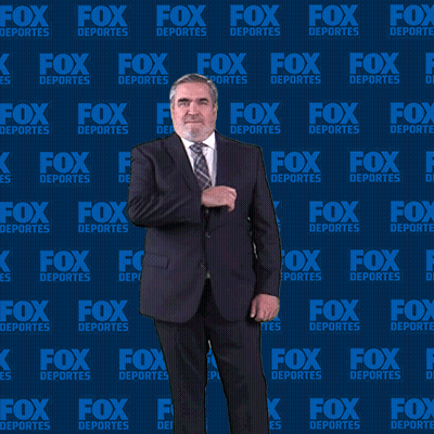 Man In Suit And Tie In Front Of Fox Deportes Backdrop GIF