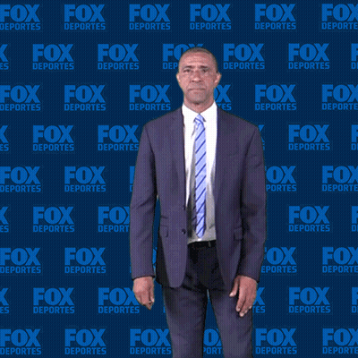 Man in Suit and Tie in Front of Fox Deportes Backdrop