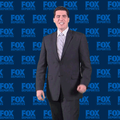 Man In Suit And Tie In Front Of Fox Deportes Background GIF