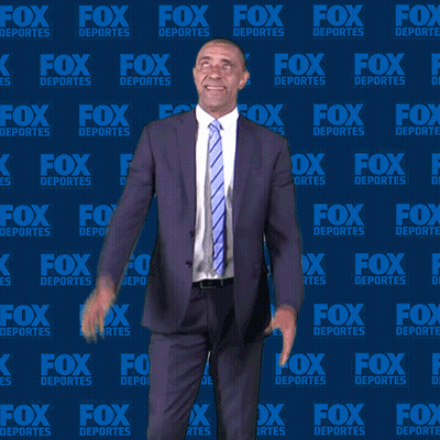 Man In Suit And Tie In Front Of Fox Deportes Background GIF