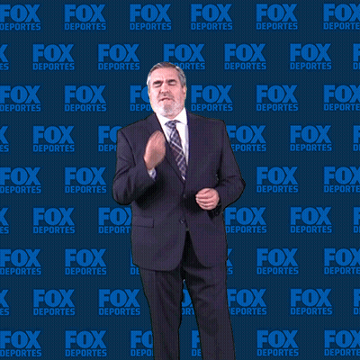 Man In Suit And Tie In Front Of Fox Deportes Wall GIF