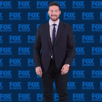 Man In Suit And Tie In Front Of Fox Deportes Wall GIF