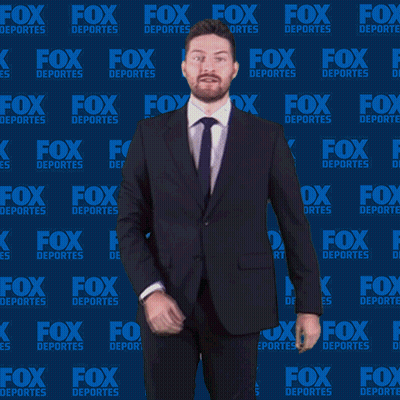 Man In Suit And Tie In Front Of Fox Deportes Wall GIF