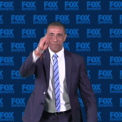 Man In Suit And Tie In Front Of Fox Deportes Wall GIF