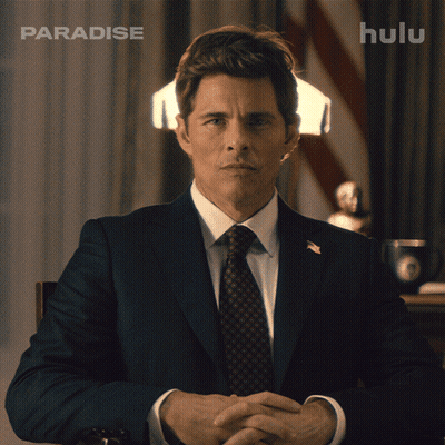 Man In Suit And Tie In Front Of Hulu Ad GIF