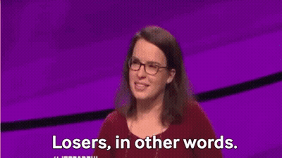 Man In Suit And Tie In Front Of Jeopardy Screen GIF