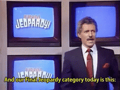 Man In Suit And Tie In Front Of Jeopardy Screen GIF