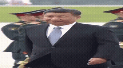 Man In Suit And Tie In Front Of Military Band GIF