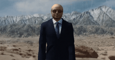 Man In Suit And Tie In Front Of Mountains GIF