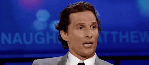 Man In Suit And Tie In Front Of Naught Sign GIF