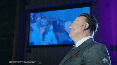 Man In Suit And Tie In Front Of NBC Screen GIF