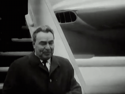 Man In Suit And Tie In Front Of Plane GIF