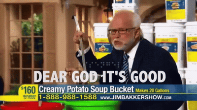 Man In Suit And Tie In Front Of Potato Soup Buckets GIF