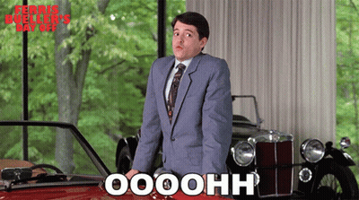 Man In Suit And Tie In Front Of Red Car Saying Oooohh GIF