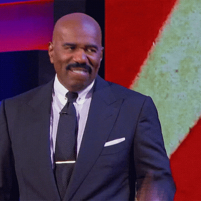 Man In Suit And Tie In Front Of Screen GIF