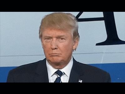 Man In Suit And Tie In Front Of Sign Saying A GIF