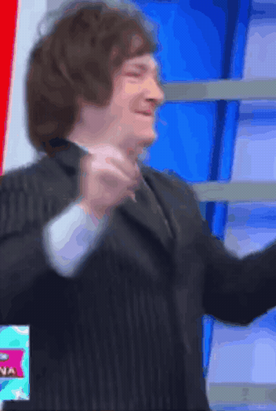 Man In Suit And Tie In Front Of Sign Saying Na GIF