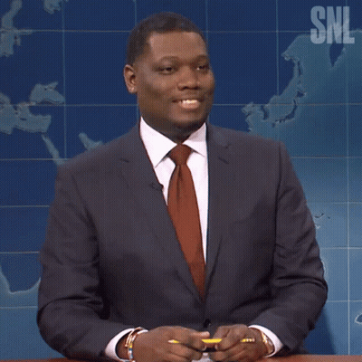 Man In Suit And Tie In Front Of SNL Map GIF