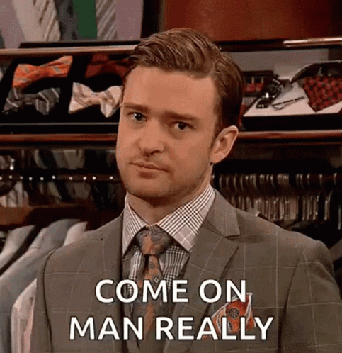 Man In Suit And Tie In Front Of Tie Display GIF