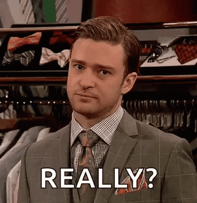 Man In Suit And Tie In Front Of Tie Display GIF