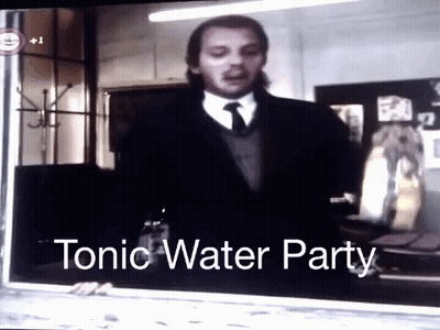 Man In Suit And Tie In Front Of Tonic Water Party GIF