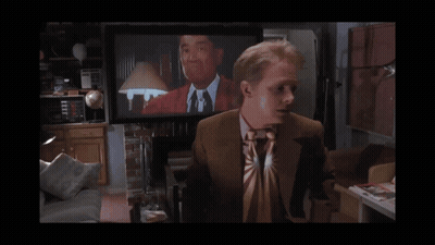Man In Suit And Tie In Front Of TV Saying McBride GIF