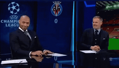 Man In Suit And Tie In Front Of UEFA Logo GIF
