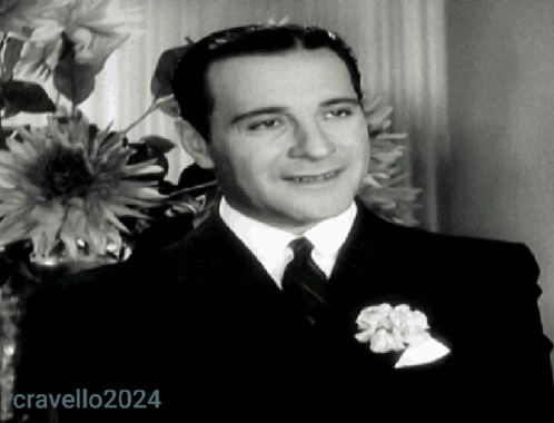 Man In Suit And Tie In Front Of Vase Of Flowers 2024 GIF