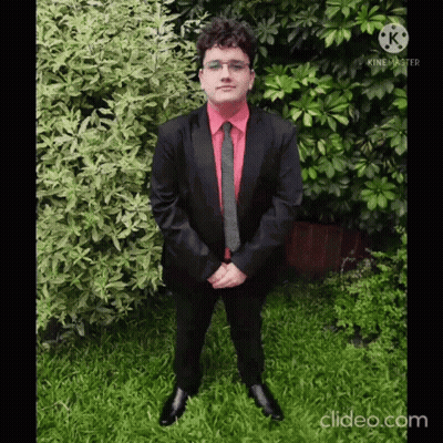 Man In Suit And Tie In Grass With Folded Hands GIF