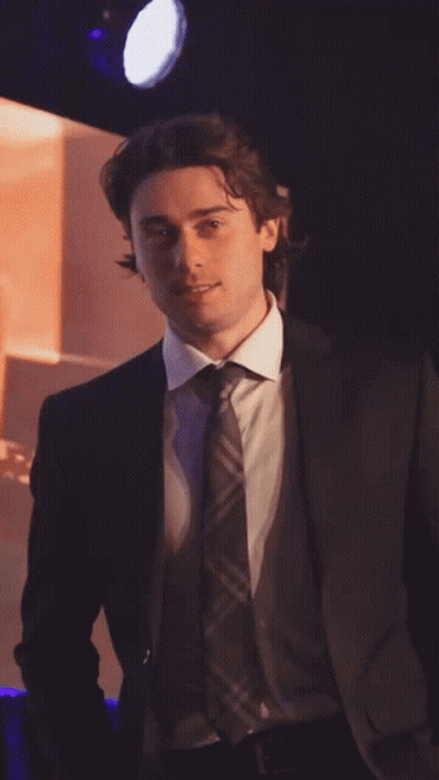 Man In Suit And Tie In Spotlight GIF