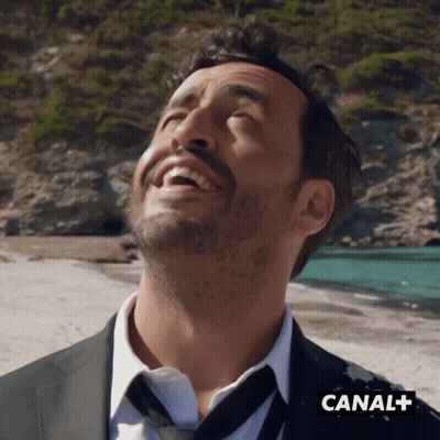 Man In Suit And Tie Laughing At Canal+ GIF