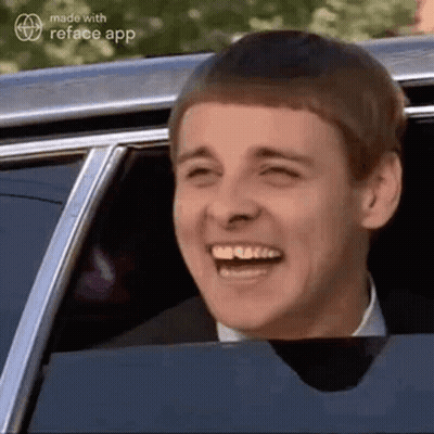 Man In Suit And Tie Laughing In Car GIF
