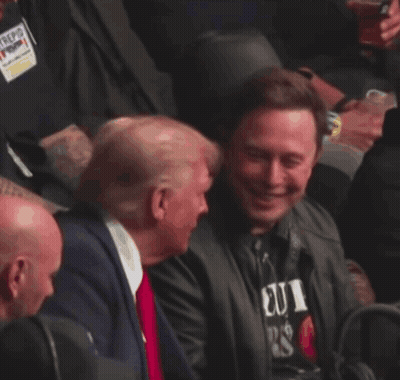Man In Suit And Tie Laughing In Crowd GIF