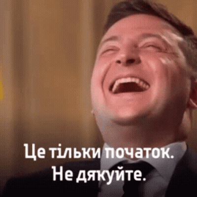 Man in Suit and Tie Laughing With Caption in Another Language